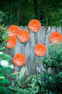 These metal flowers add texture and color to a fence