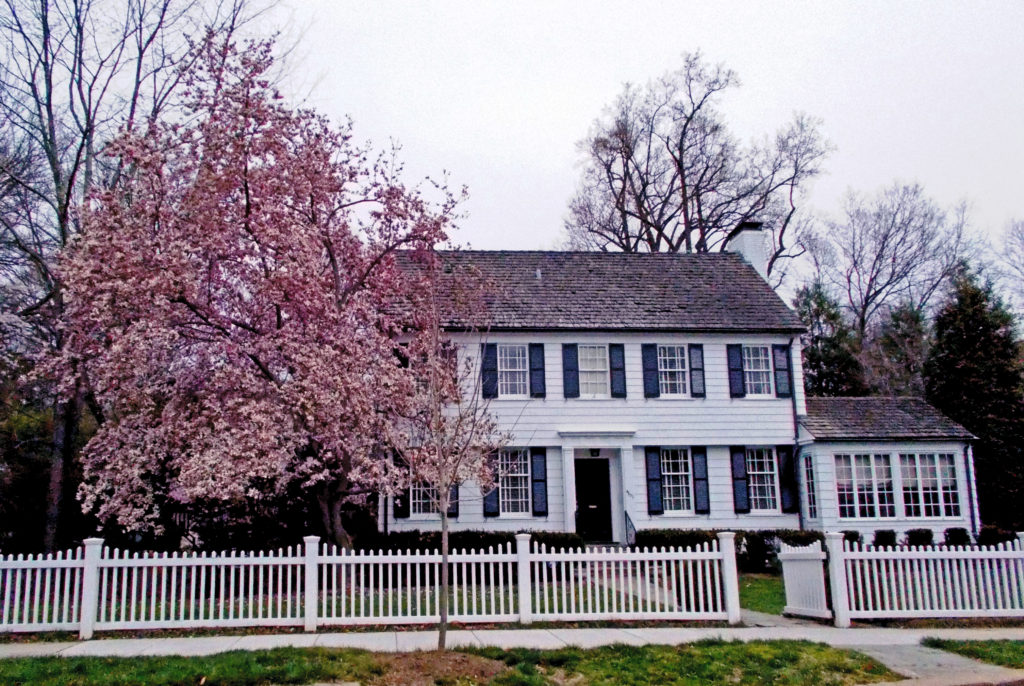 colonial home with picket fence